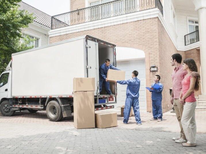 movers carrying heavy furniture out of a house and into a moving van in Hidden Valley Lake